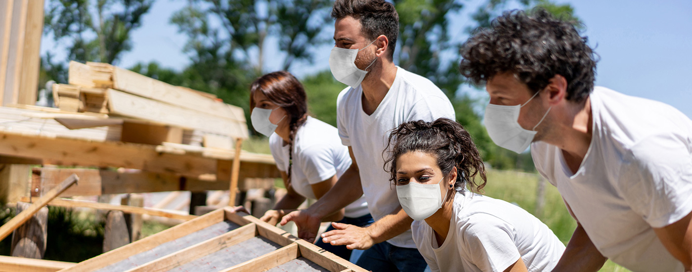 Volunteers help build a house.