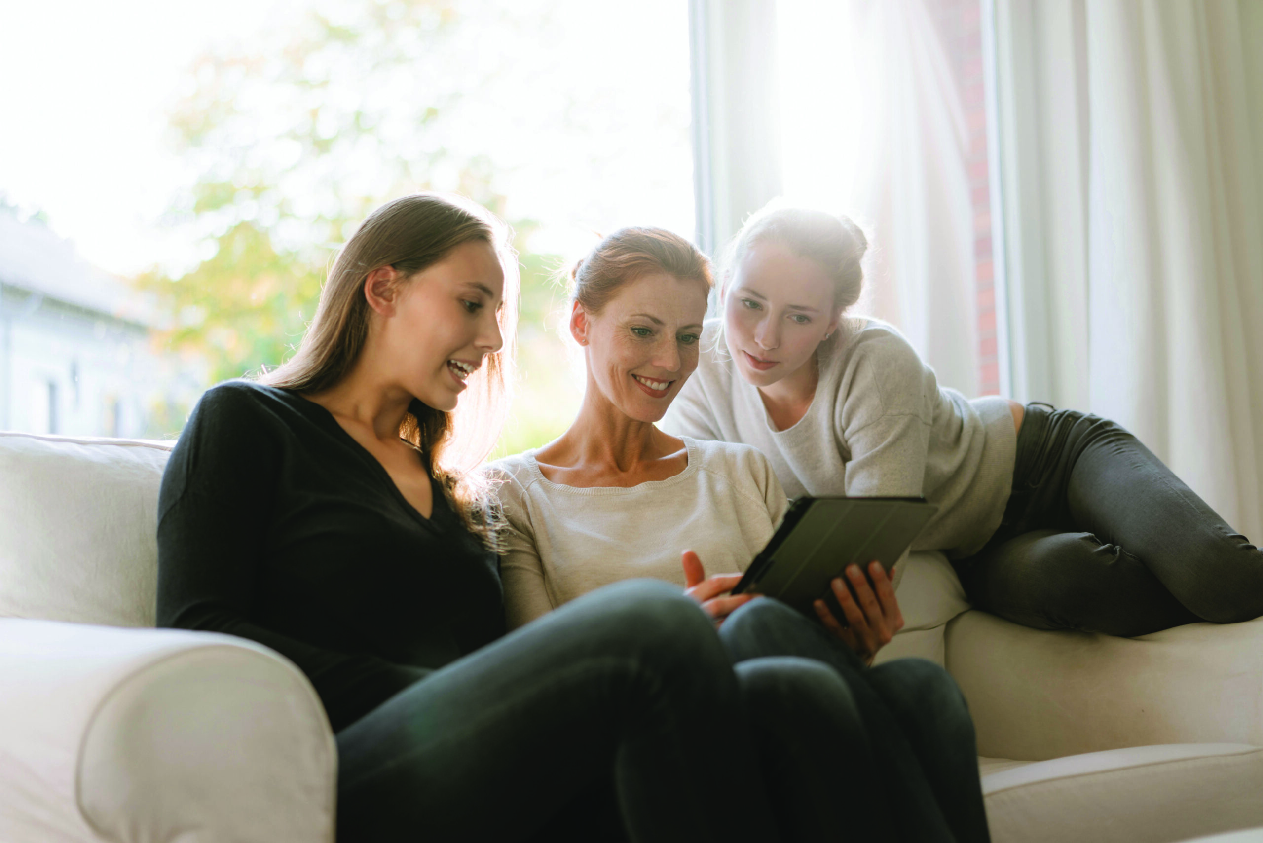 Mother sharing information with two daughters