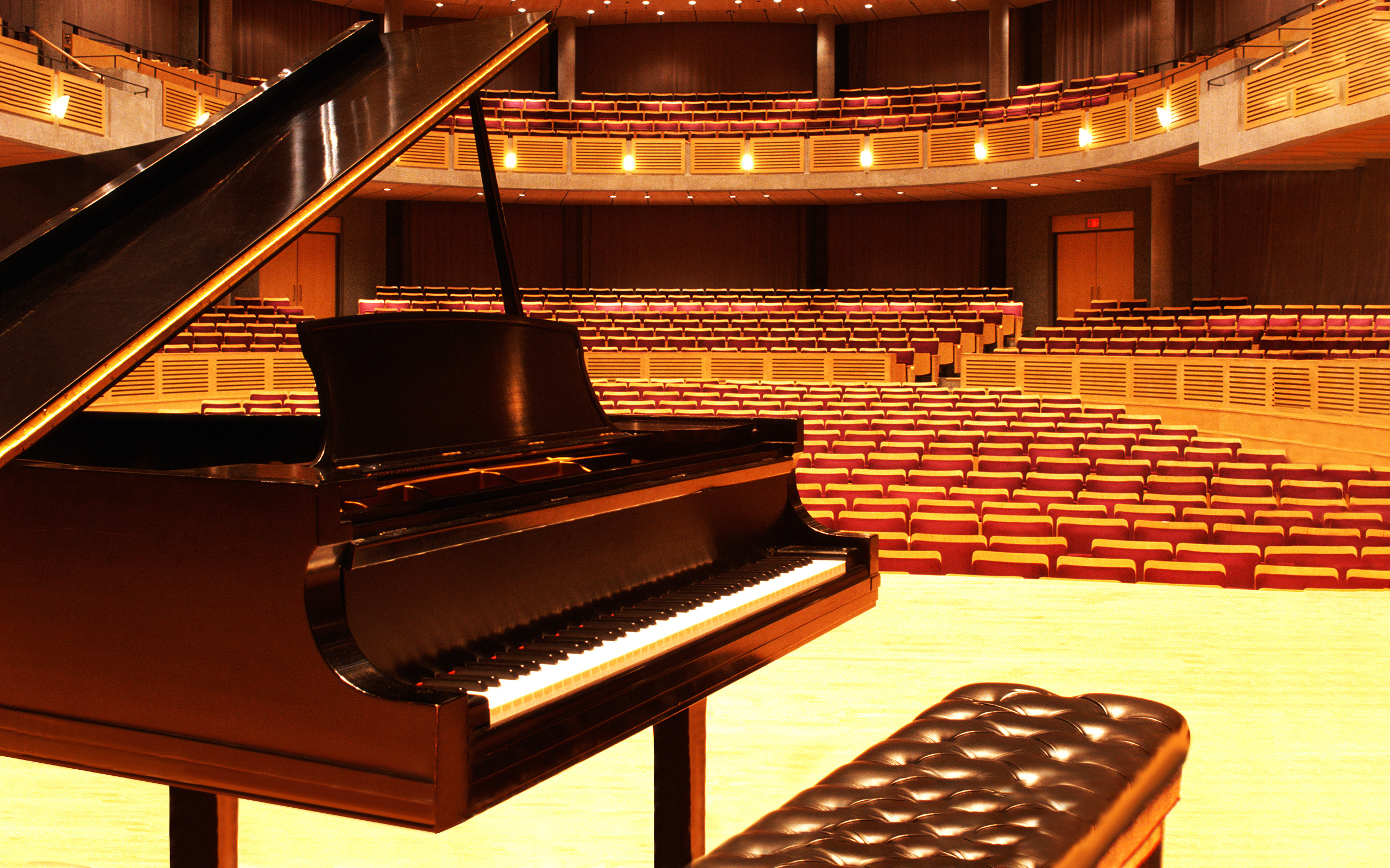 a baby grand piano on a concert hall stage