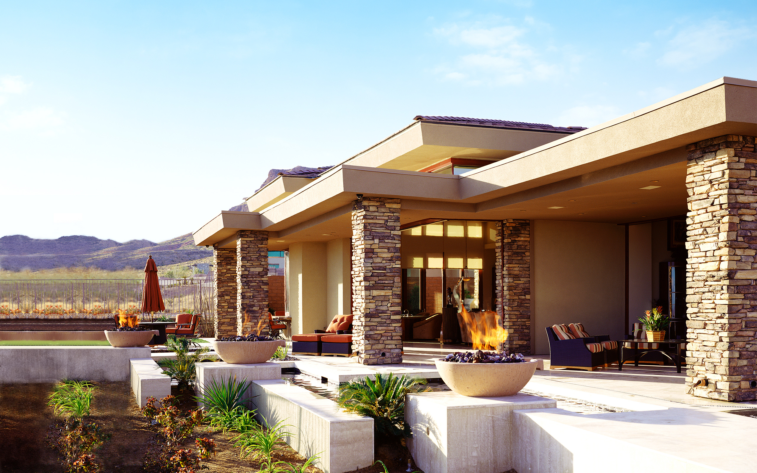 Outside view of a Modern house with a fire pits and a view of mountains