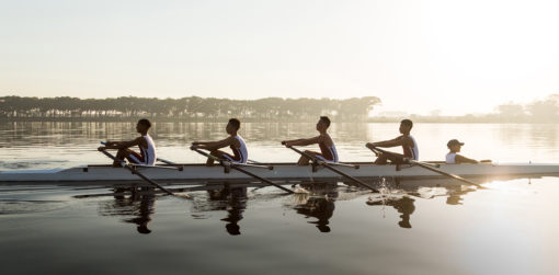 Four-person rowing team races across the water