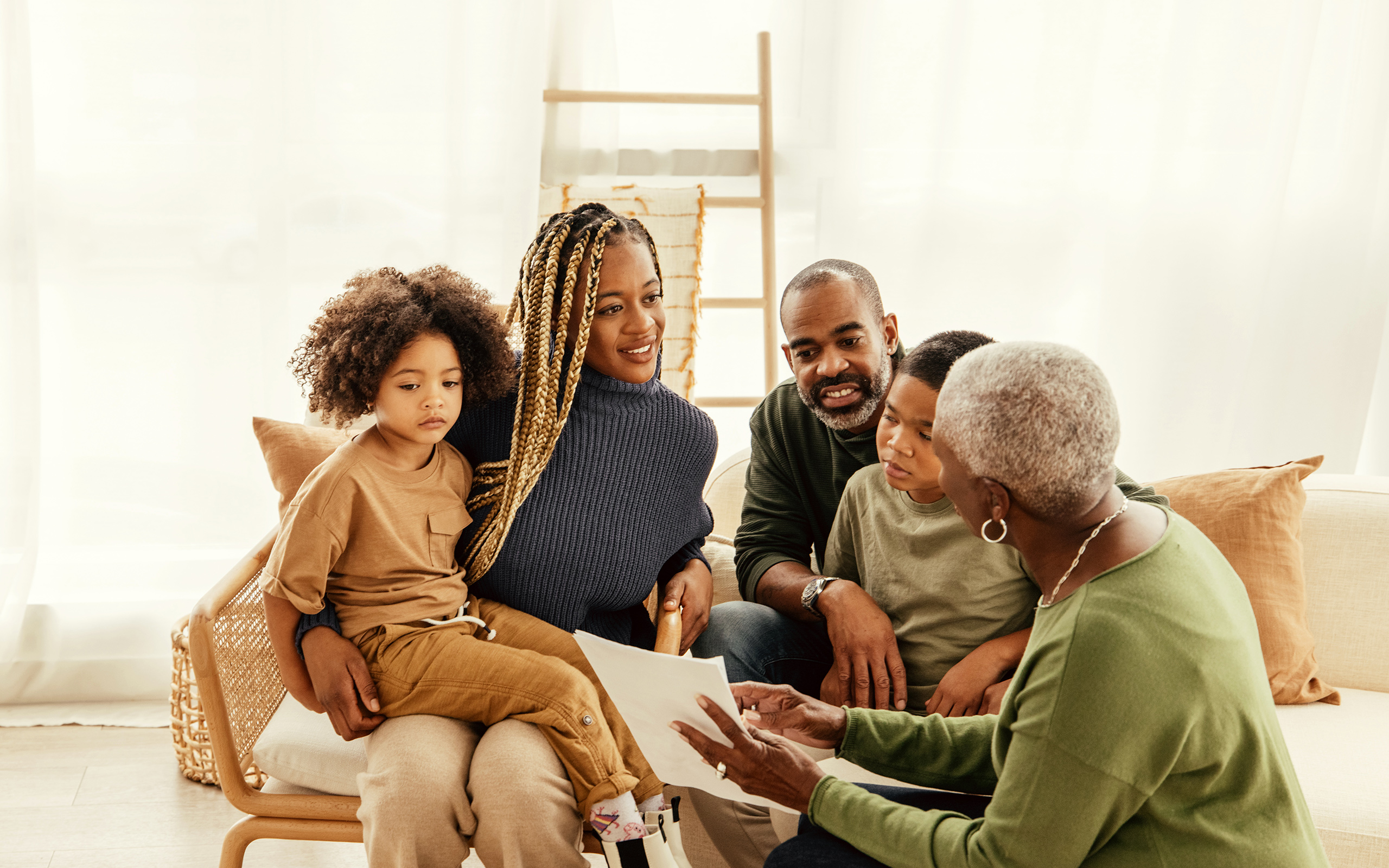 An older woman talks to her children and grandchildren