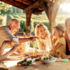 Multigenerational family seated at a table under a gazebo