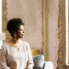 Woman seated in the living room looking out the window