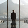 Businessman standing in office looking out the window.