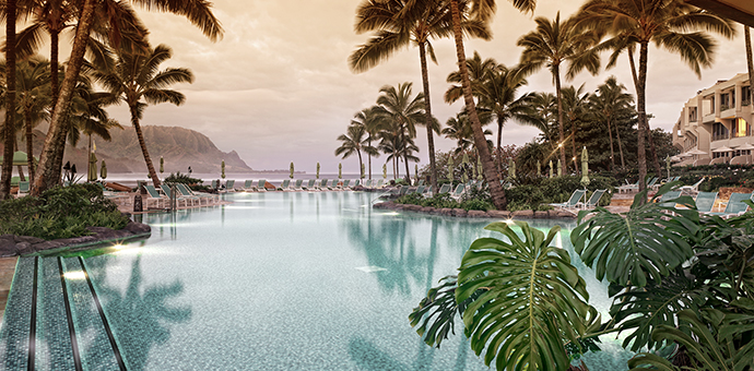 Luxurious Hawaiian 5-star resort with pool view toward ocean and mountains.