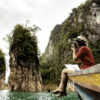 Woman taking photo sitting on a boat