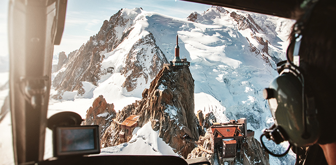 Landscape aerial view of French alps mountains from helicopter cockpit.