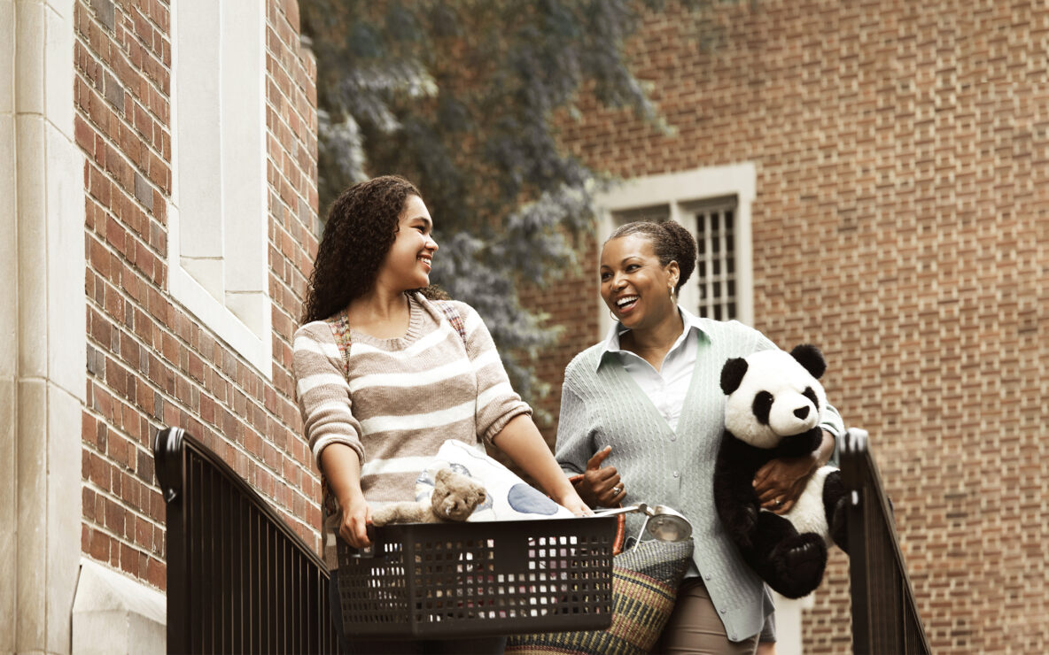 Mother helping daughter move into dormitory.