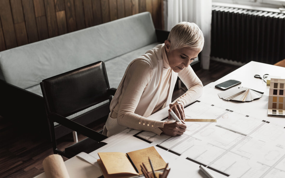 Businesswoman drawing plans from home studio.