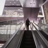 Businessman on top of moving escalator