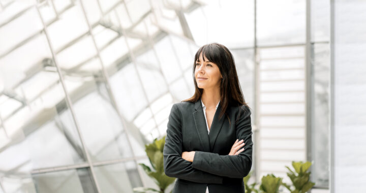 Businesswoman with arms crossed smiling.