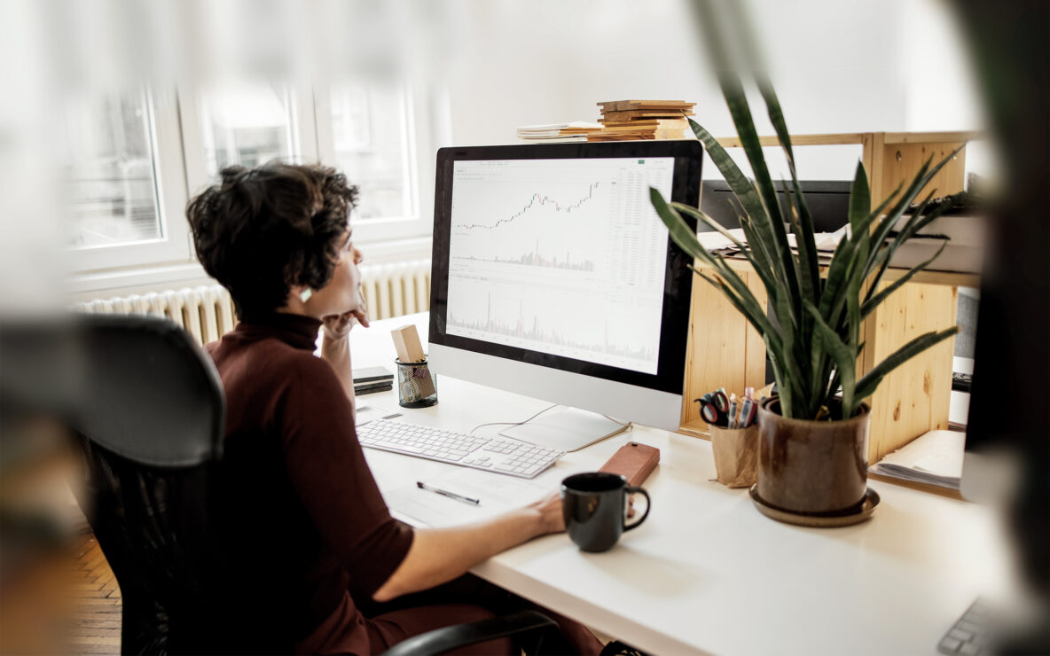 Young woman examining the changes in the stock market at her office.