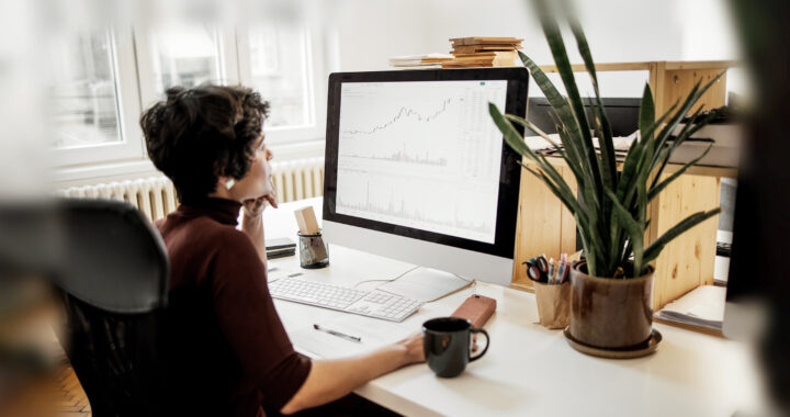 Young woman examining the changes in the stock market at her office.