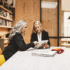 Two businesswomen meeting in a conference room.