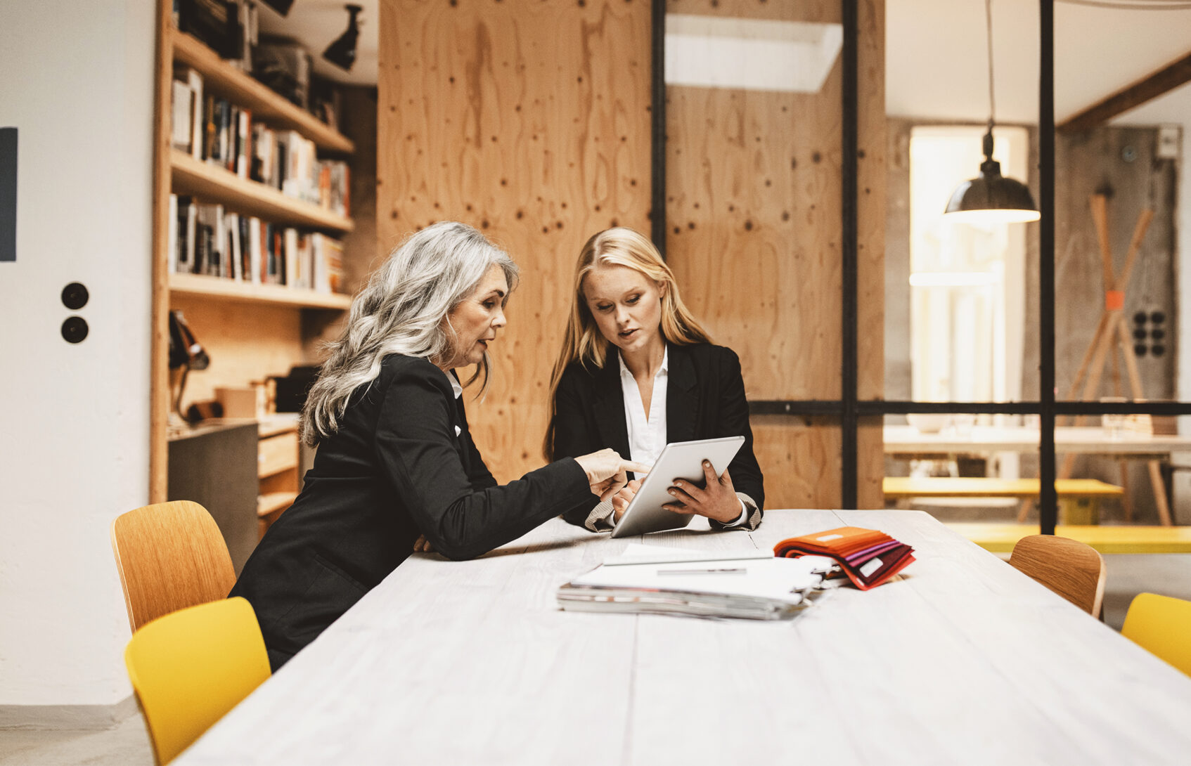 Two businesswomen meeting in a conference room.