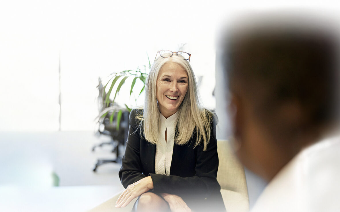 Businesswoman seated across from client