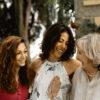 Three generations of female family together smiling.