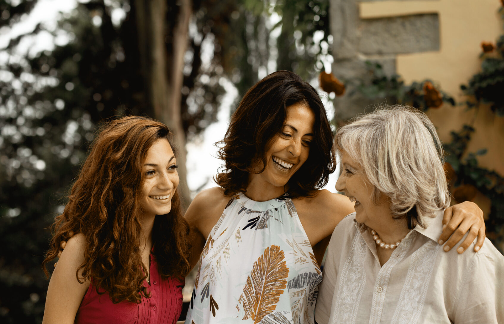 Three generations of female family together smiling.