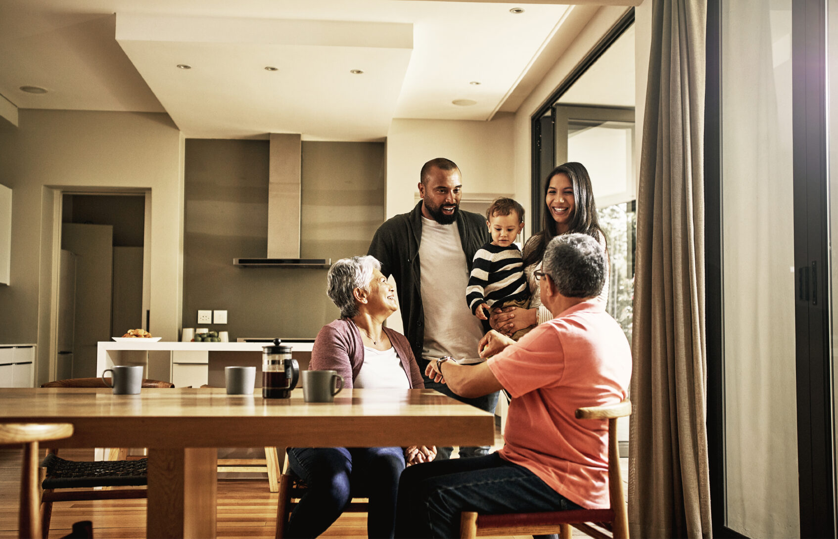 A multigenerational family talking in the kitchen