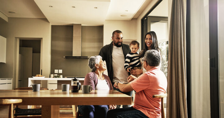A multigenerational family talking in the kitchen