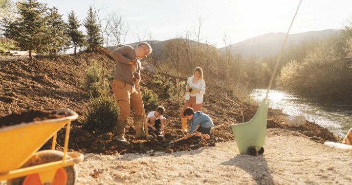 A family planting trees together.